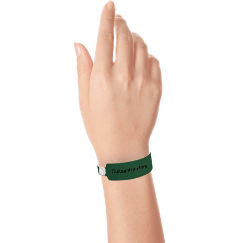 Hand wearing wide face vinyl wristbands with a placeholder to show where you can customize the wristband in forest green