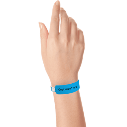 Hand wearing wide face vinyl wristbands with a placeholder to show where you can customize the wristband in neon blue 