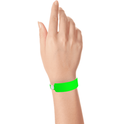 Wide face vinyl solid wristbands on hand in neon green