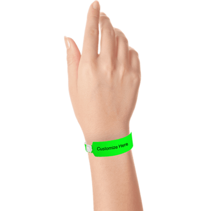 Hand wearing wide face vinyl wristbands with a placeholder to show where you can customize the wristband in neon green