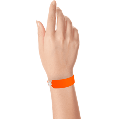 Wide face vinyl solid wristbands on hand in neon orange