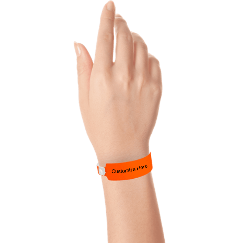 Hand wearing wide face vinyl wristbands with a placeholder to show where you can customize the wristband in neon orange
