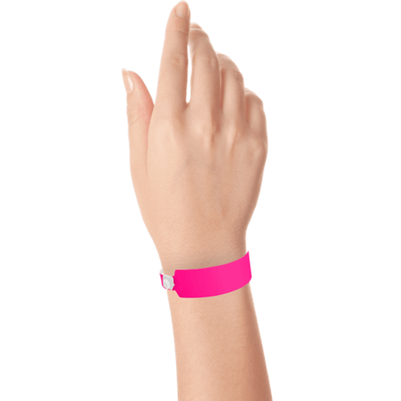 Wide face vinyl solid wristbands on hand in neon pink