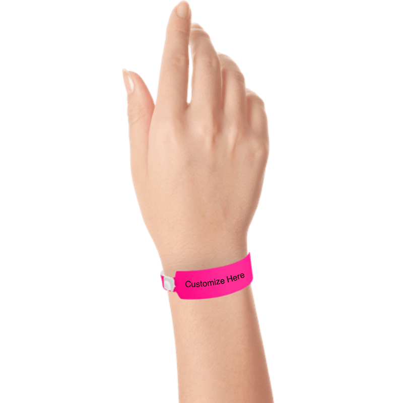 Hand wearing wide face vinyl wristbands with a placeholder to show where you can customize the wristband in neon pink