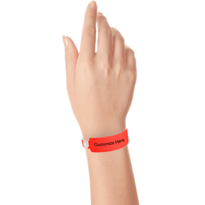 Hand wearing wide face vinyl wristbands with a placeholder to show where you can customize the wristband in neon red
