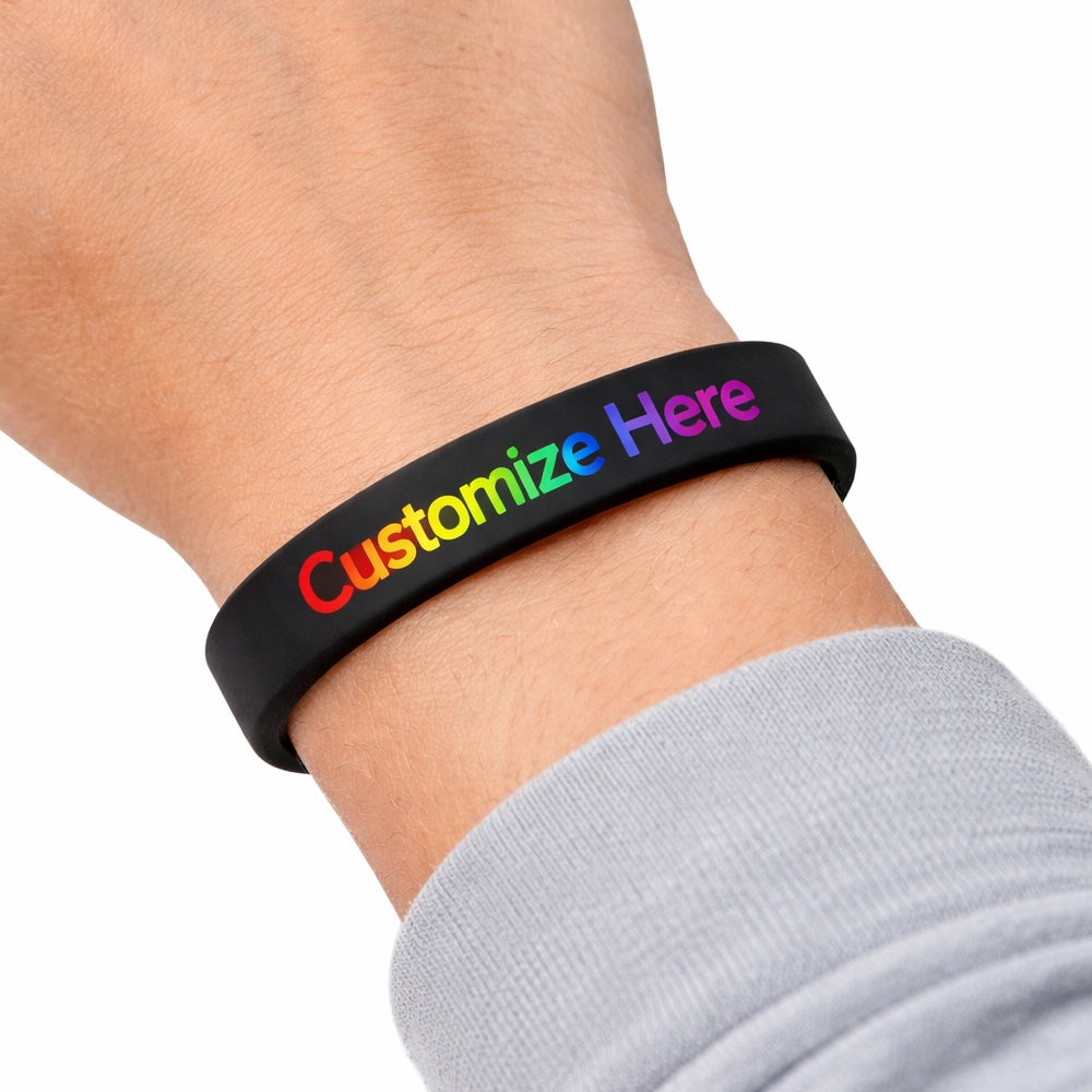 printed silicone wristband on a wrist in black with multi colour print