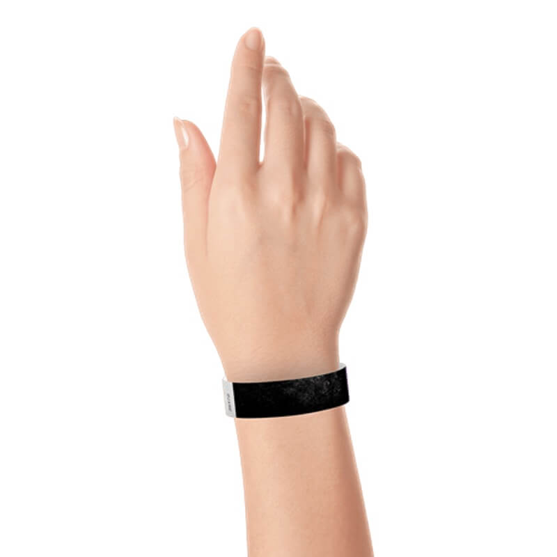 hand wearing a  3/4" tyvek wristband solid black