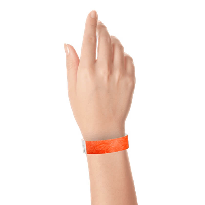 hand wearing a  3/4" tyvek wristband solid coral red