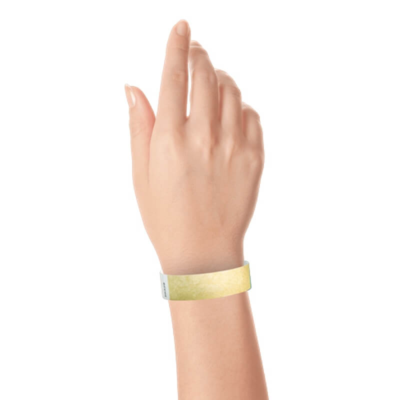 hand wearing a  3/4" tyvek wristband solid gold