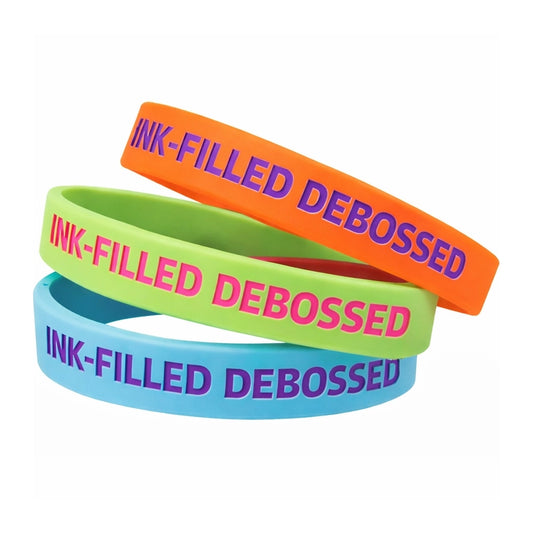 ink filled debossed silicone wristbands blue (purple fill), lime (pink fill) and orange (purple fill)