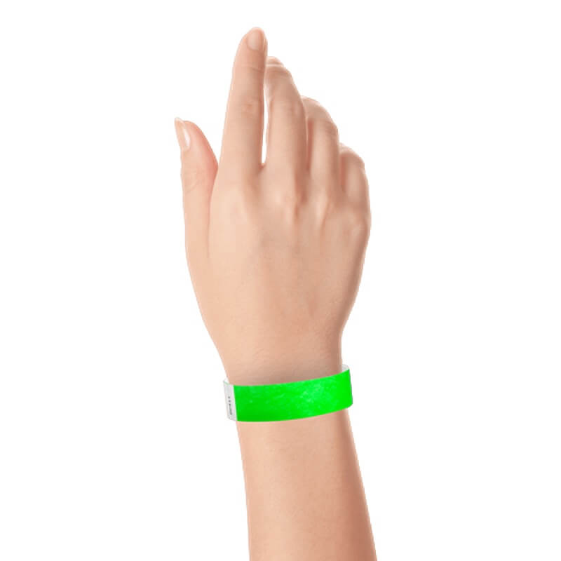 hand wearing a  3/4" tyvek wristband solid neon green