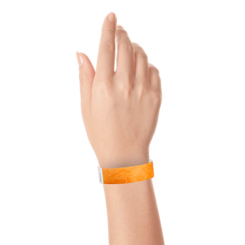 hand wearing a  3/4" tyvek wristband solid neon orange
