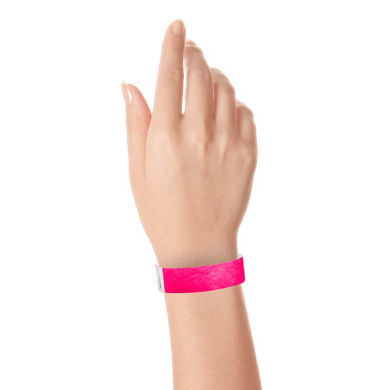 hand wearing a  3/4" tyvek wristband solid neon pink
