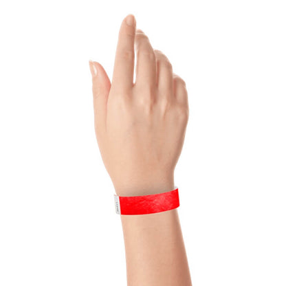hand wearing a  3/4" tyvek wristband solid neon red
