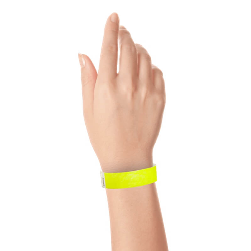 hand wearing a  3/4" tyvek wristband solid neon yellow