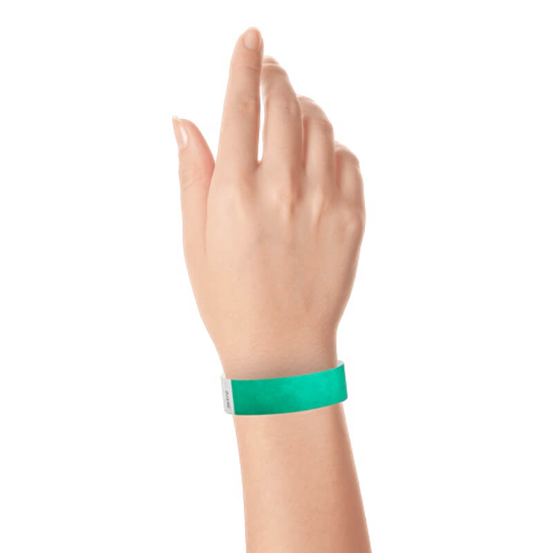 hand wearing a  3/4" tyvek wristband solid pantone green